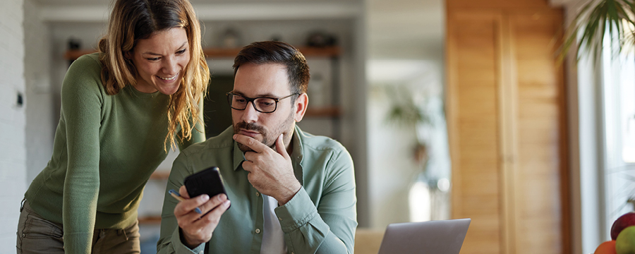 Young couple looks at content on smart phone