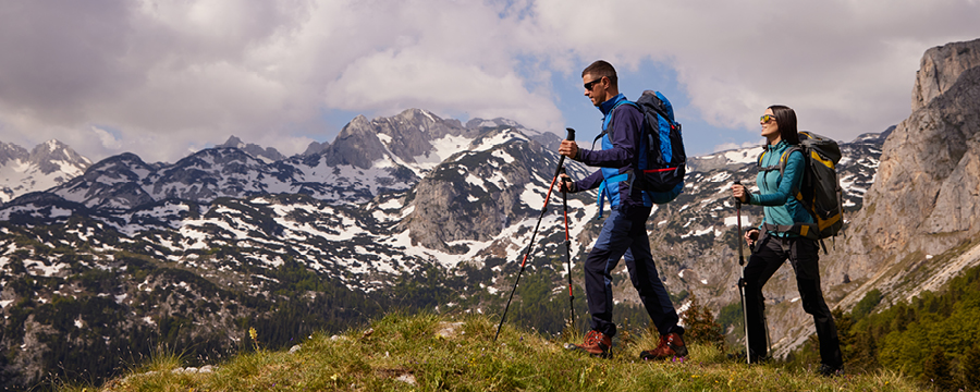 Woman and man hiking in mountains